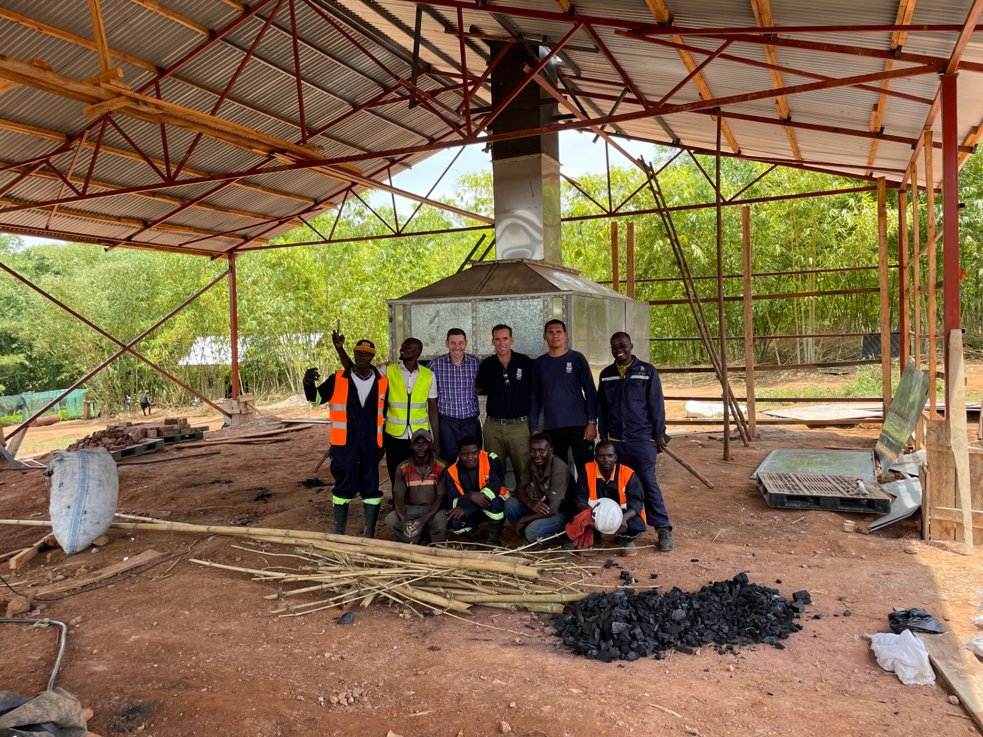 Ugandan Biochar Alliance facility - brick kiln shelter with the project team